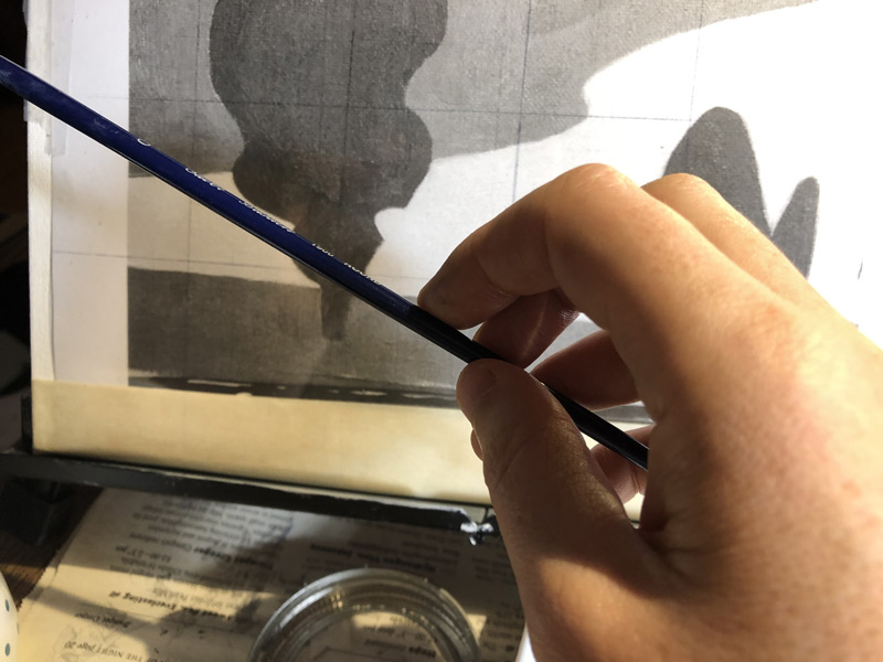 holding up brush to check angle